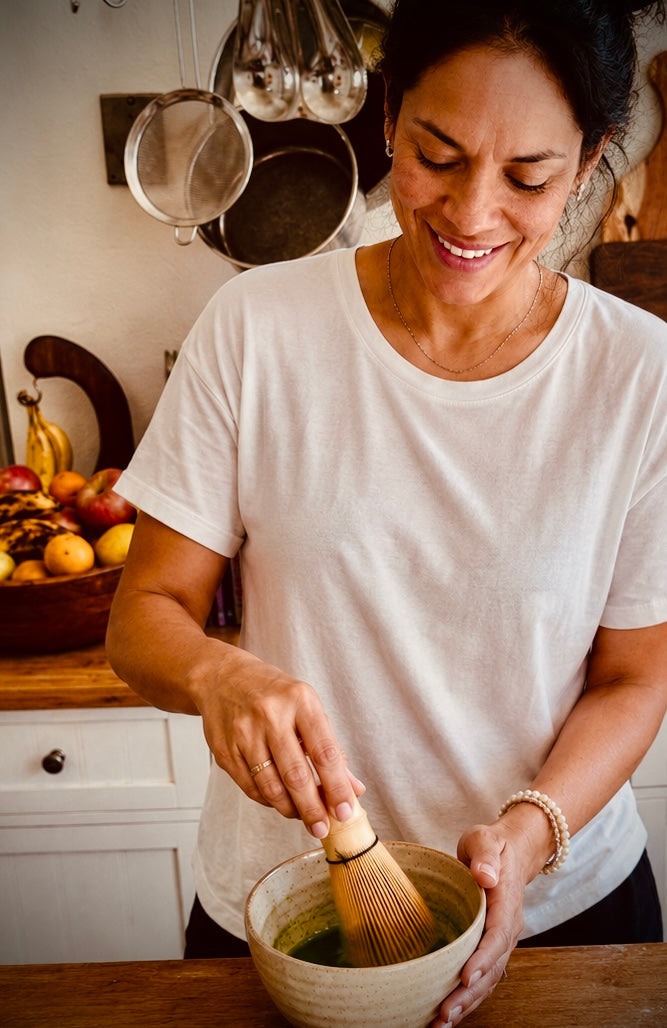 woman whisking matcha