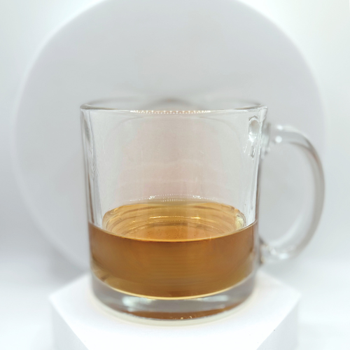 Image of light colored tea in a clear mug on a white background