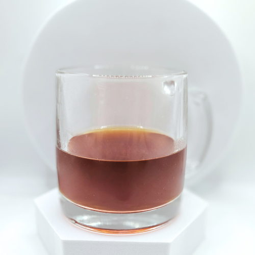 Dark colored Chaiin a clear mug on a white background 