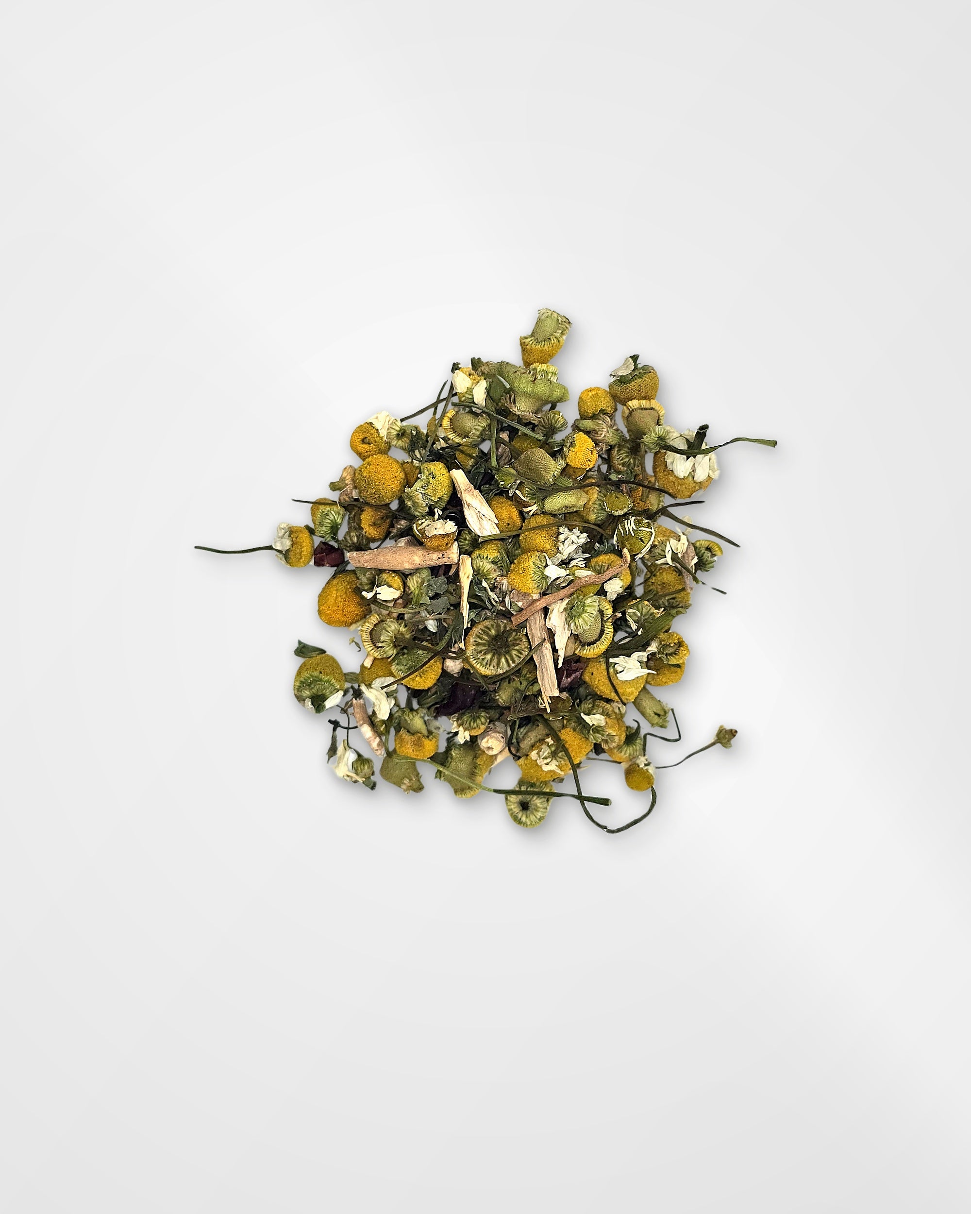 A small pile of loose-leaf herbal tea or dried botanicals with yellow-orange flower petals, green leaves, and thin dark stems, centered on a plain light gray background.