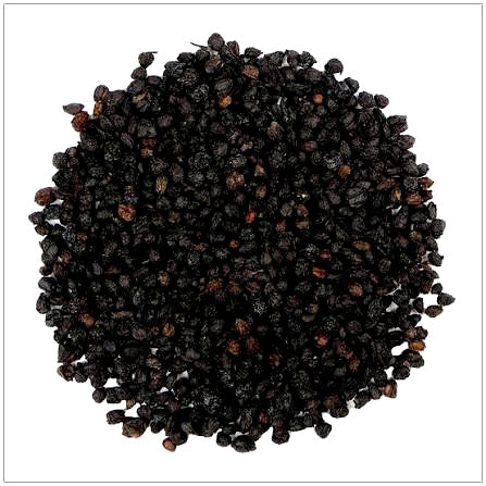 A pile of dried black elderberries with small reddish-brown stems, photographed from above on a white background.