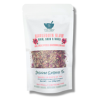 Tea package front labeled 'Harlequin Glow' with visible tea leaves on a white background