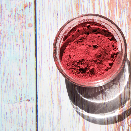 Image of Hibiscus Matcha in a clear bowl on a woodgrain surface