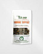 A white stand-up pouch of 'The Tea Shop' Cinnamon Elderberry Immune Support herbal tea blend, featuring a clear window showing the loose leaf tea inside.