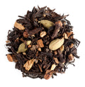 Spiced black tea leaves with cardamom pods,cloves and ginger on a white background