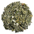 A circular pile of dried, chopped green leaves and stems, likely a herbal tea or dietary supplement blend, isolated on a solid white background.