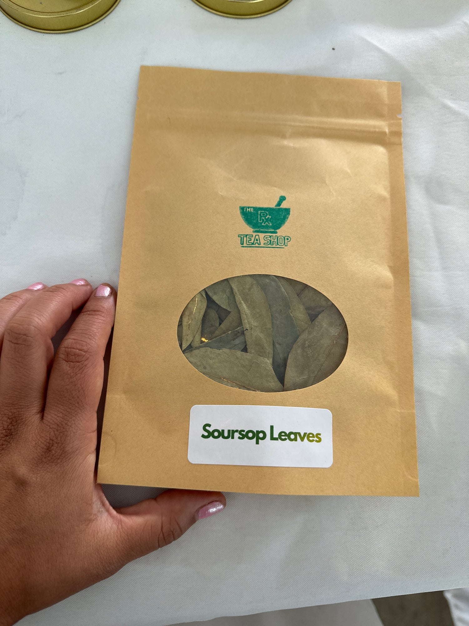 Image of medium craft bag containing soursop leaves on white table cloth
