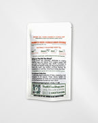 A single white tea bag packet from The RX Tea Shop is shown against a light gray background. The packaging features black and orange text detailing the flavor profile of black tea, peach, and stevia leaf, along with product information and a QR code.