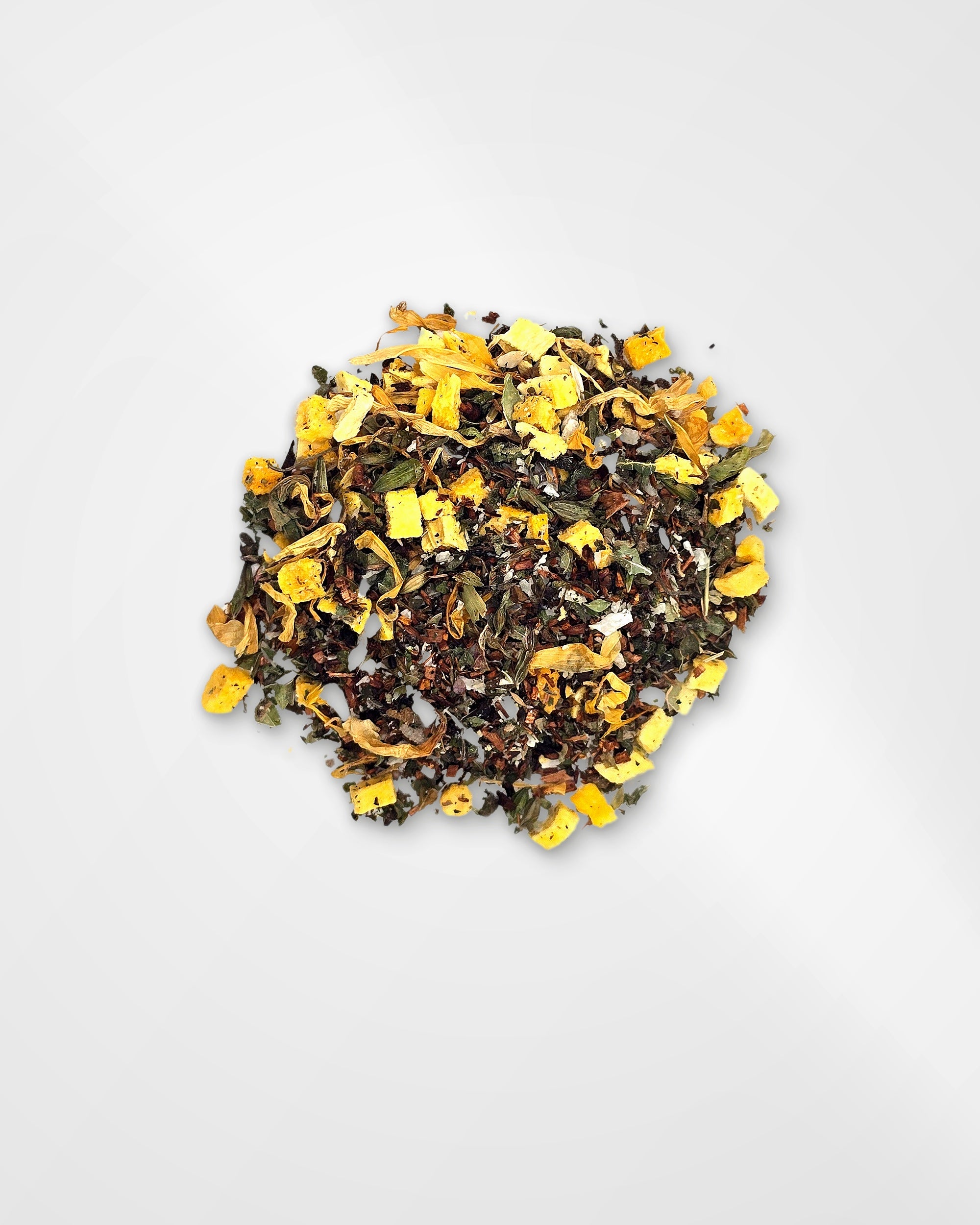 A small pile of loose-leaf herbal tea blend with visible yellow dried flower pieces, green leaves, and dark tea leaves on a clean white background.
