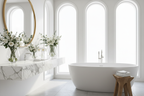 a beautiful bathroom with flowers, a luxurious modern bathtub, a sun light white marble countertop and an oversized mirror