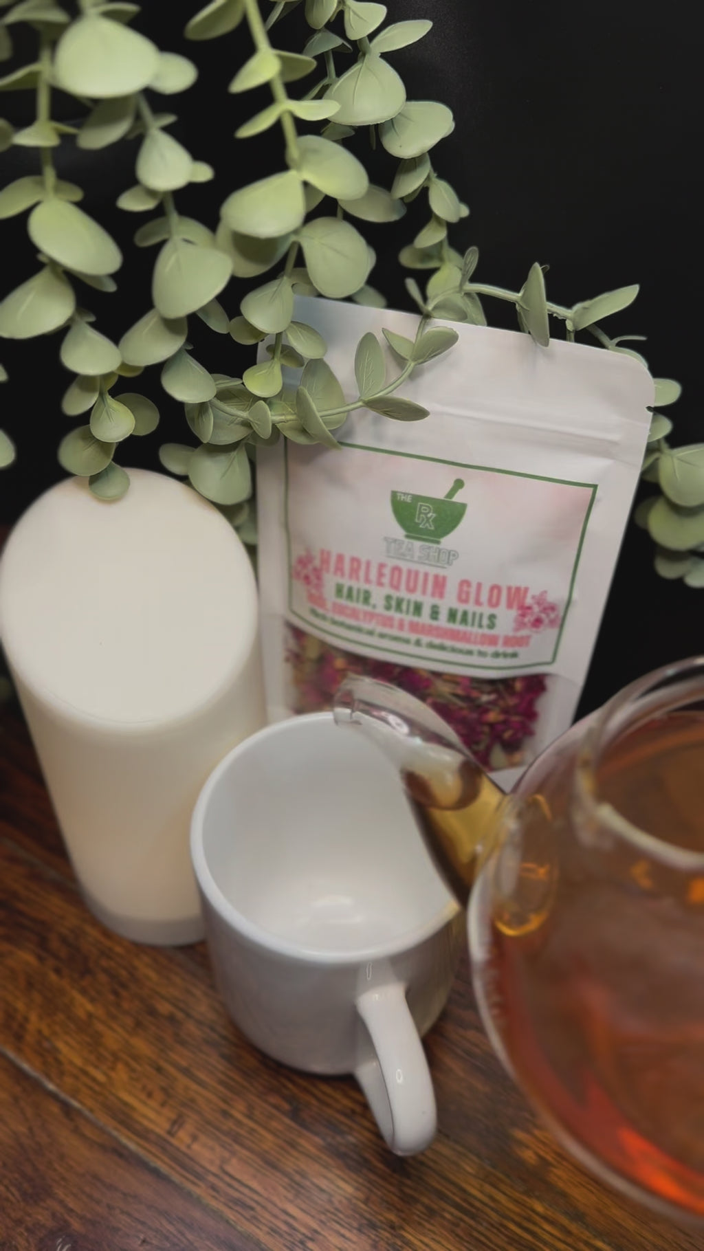 Short Video clip of Harlequin Glow tea being poured into a white teacup with earthy toned background