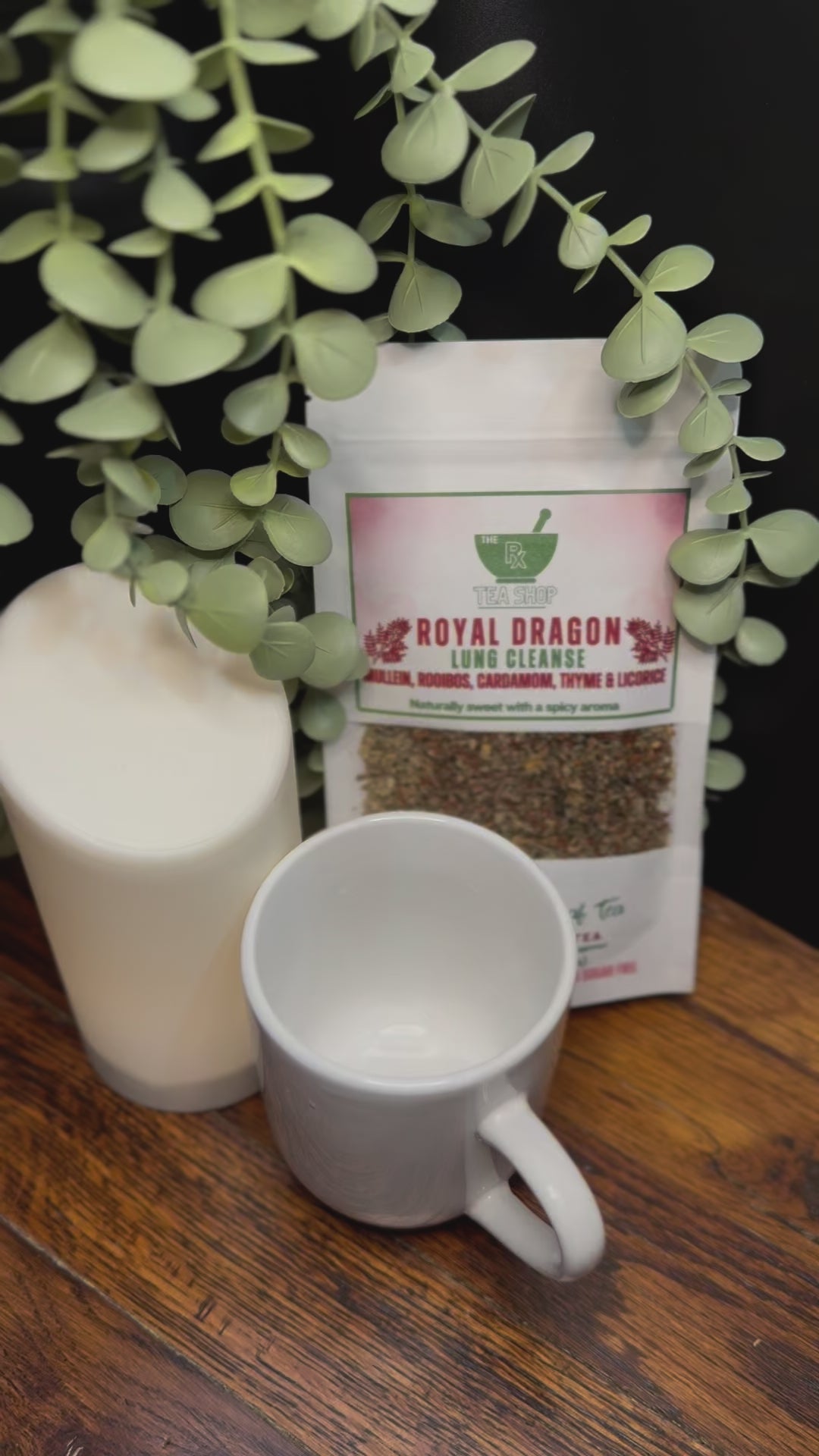 Short video clip of Royal dragon tea being poured into white mug from clear teapot with green scenery 